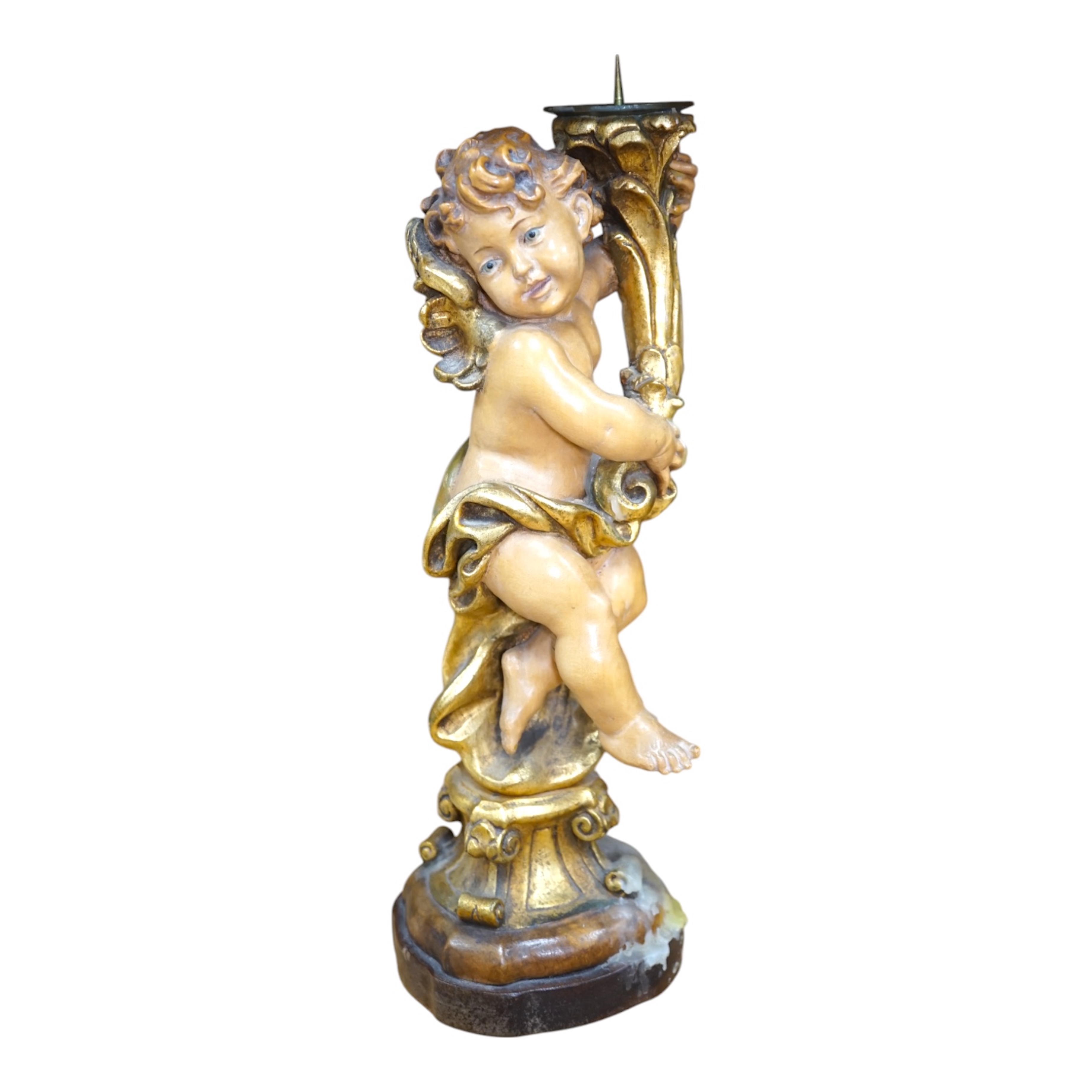 An Austrian carved and partially gilt cherub pricket candlestick, 37cm high. Condition - fair to good